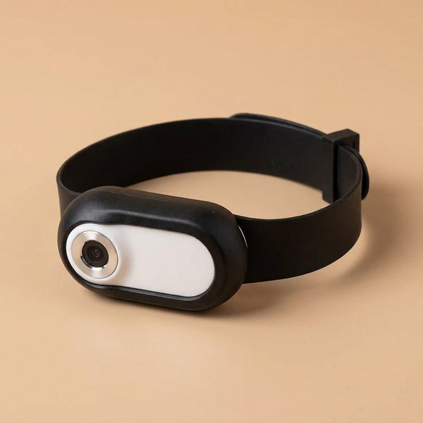 Black and white Casa Michi cat camera collar with adjustable strap, studio three-quarter view