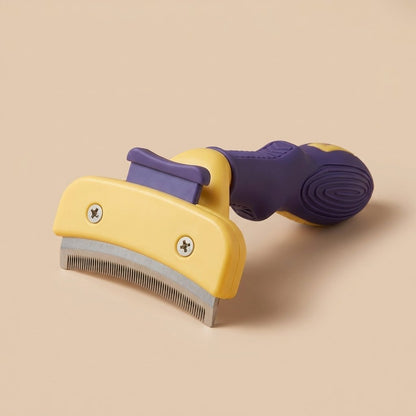 Purple and yellow cat detangling comb with steel deshedding blade, studio three-quarter view