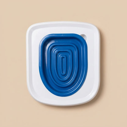 Blue cat toilet trainer insert with concentric rings in white square frame, top view