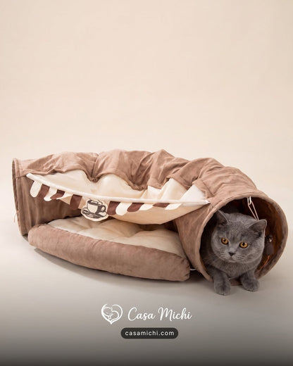 Plush cat tunnel bed front view showing center cushion and side tunnel openings