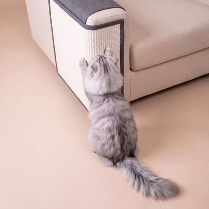High-angle view of grey cat reaching up to sisal sofa scratch protector
