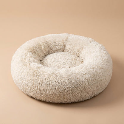 Casa Michi cream shaggy donut cat bed, three-quarter studio view on tan background