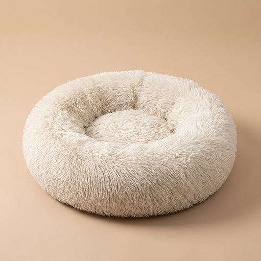 Casa Michi cream shaggy donut cat bed, three-quarter studio view on tan background
