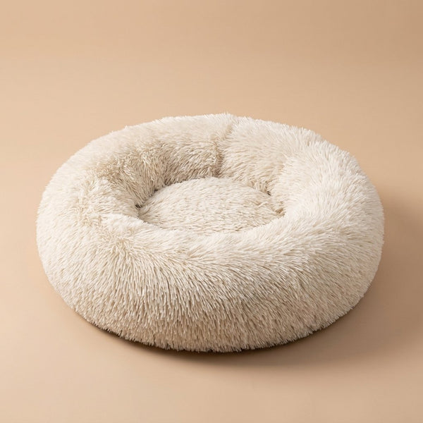 Casa Michi cream shaggy donut cat bed, three-quarter studio view on tan background