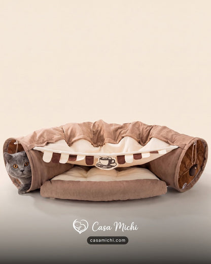 Grey British Shorthair peeking from mocha cafe cat tunnel bed with striped awning