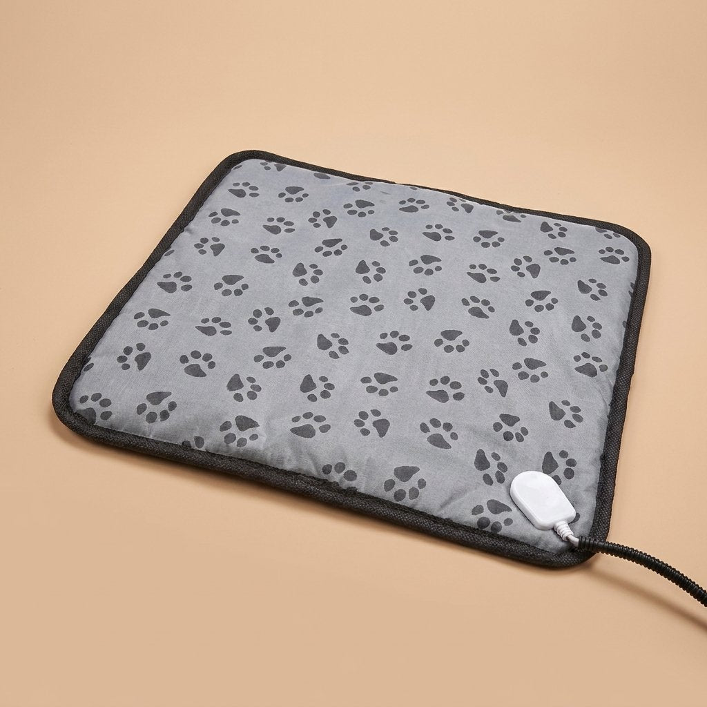 Grey paw-print cat heating pad flat studio shot with chew-guard cord sleeve
