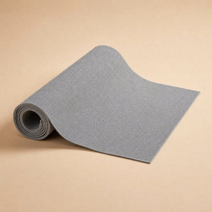 Grey anti-scratch sofa mat partially rolled to show flexible ribbed texture
