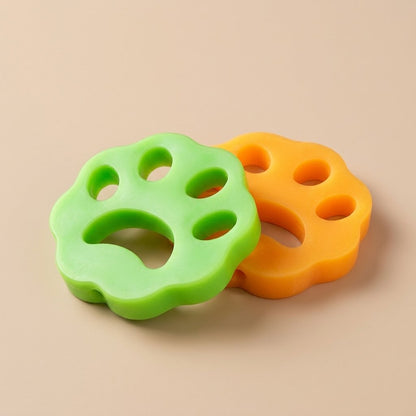 Lime green and orange paw cat hair removers product pair, studio flat lay