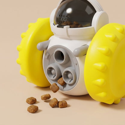 White treat dispenser toy with yellow knobby wheels and kibble at the treat holes